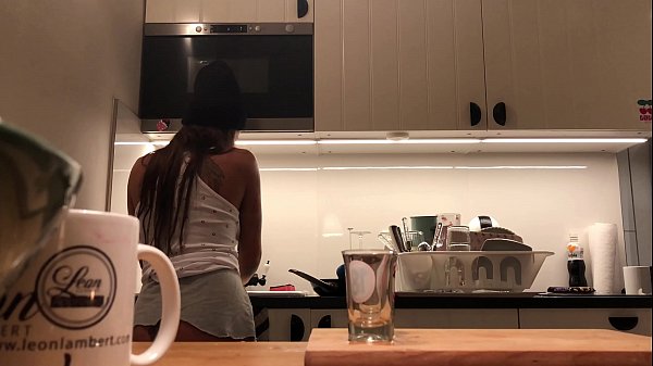 braless no panties in the kitchen finishes the dishes