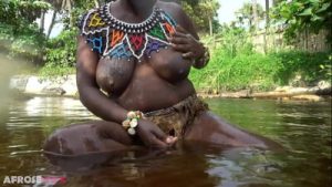 Big tittie zulu aunty washing herself in a tropical forrest river