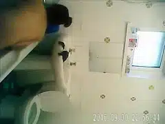 Bathing woman washes her long dark hair