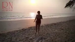 Nice lady at lonely nudist beach. Red swimsuit. Red bikini. Coconut